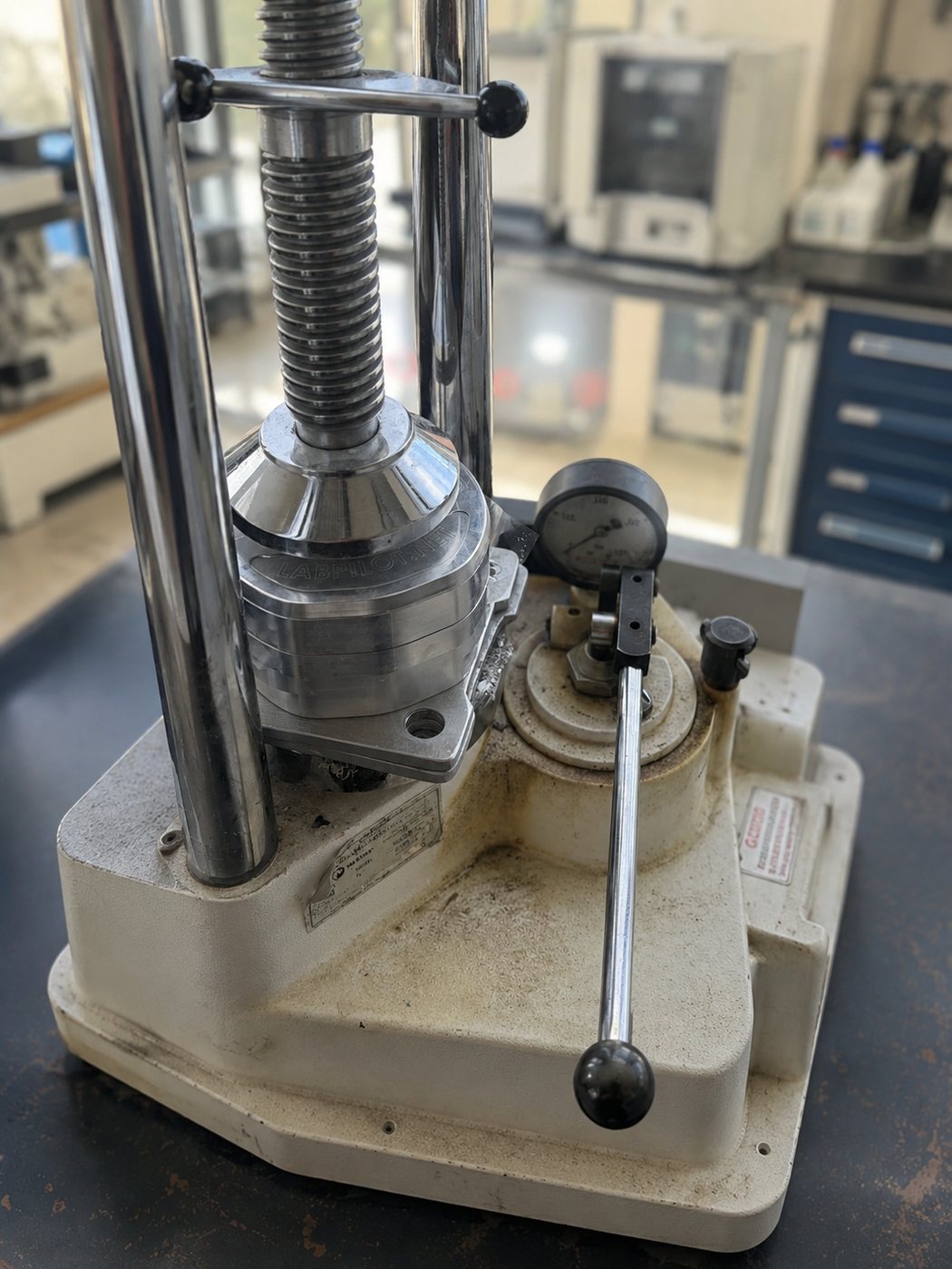 Metal flask compressed in a laboratory flask press