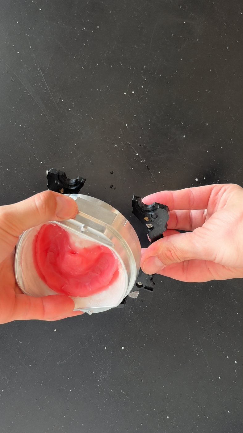 Hands attaching the flask case to the mill holder